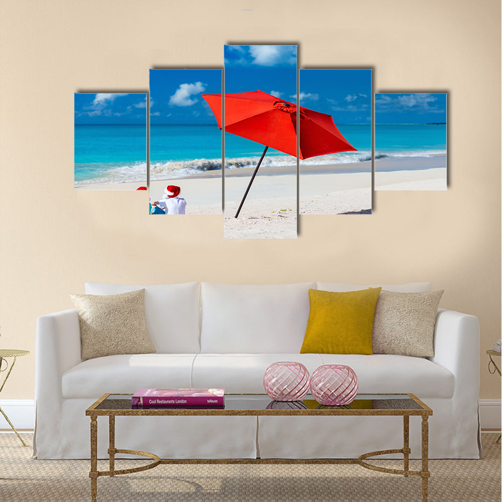 Kids in red Santa hats having fun at tropical beach during Christmas vacation Multi panel canvas wall art