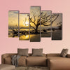 A flock of gulls flies over a driftwood covered beach at sunrise wall art