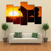 Silhouette Of A Akita Inu Dog At Golden Sunset. Multi Panel Canvas Wall Art