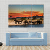 Herd of elephants in african savanna at sunset Multi panel canvas wall art