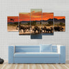 Herd of elephants in african savanna at sunset Multi panel canvas wall art