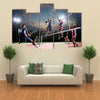 volleyball players in action on the open air court Multi panel canvas wall art