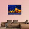 Snowy winter scene of a cabin in distance at night multi panel canvas wall art