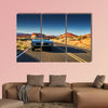 Man driving vintage car through desert multi panel canvas wall art