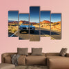 Man driving vintage car through desert multi panel canvas wall art