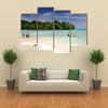 Vanuatu boys cross by foot and boat at low tide the channel over the sand bar Multi panel canvas wall art