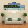 Vanuatu boys cross by foot and boat at low tide the channel over the sand bar Multi panel canvas wall art