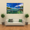 Natural infinity rock pool with palm trees over tropical ocean lagoon multi panel canvas wall art