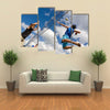 A volleyball player jumps to spike while another prepares to competition Multi panel canvas wall art