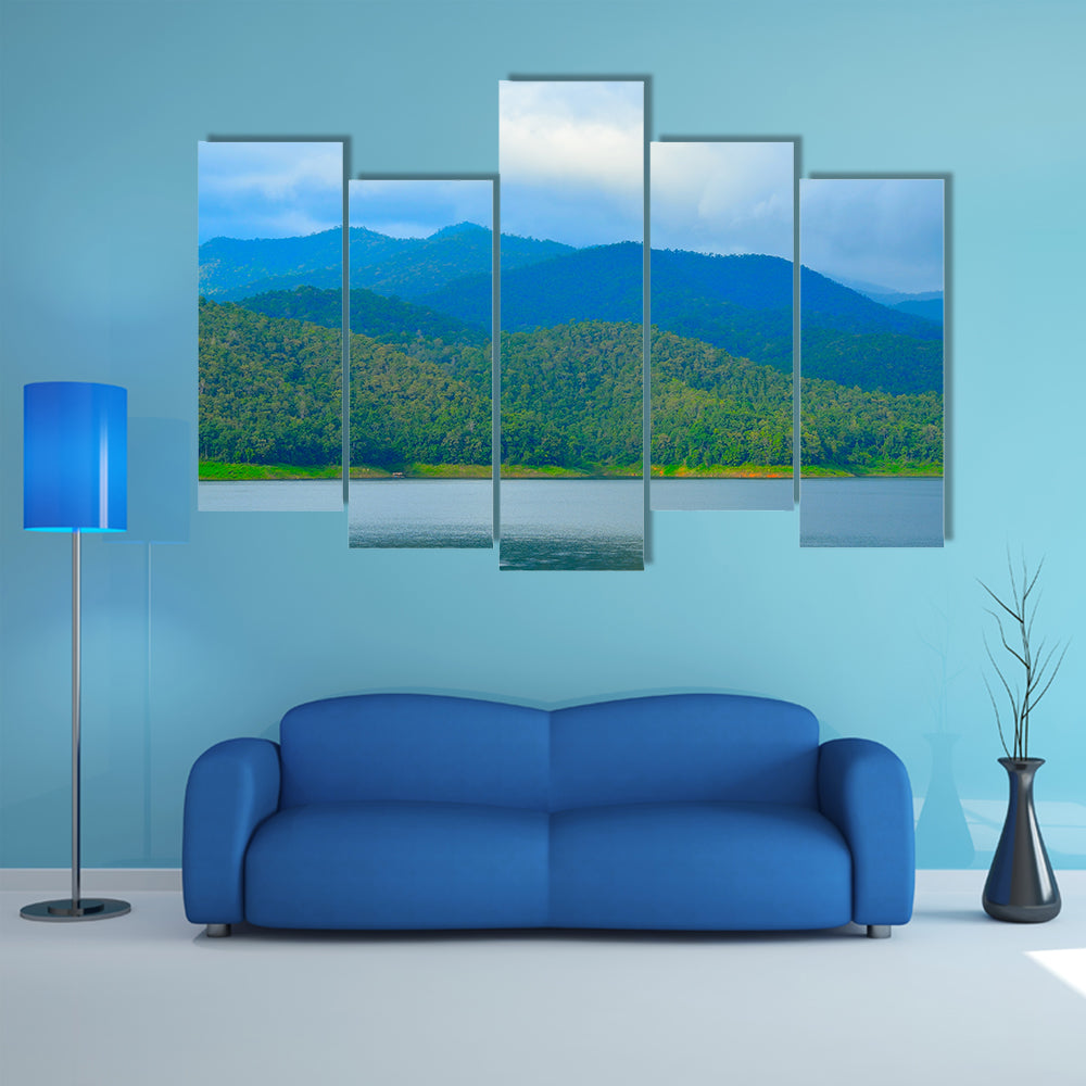 View of mountain forest landscape with heavy blue sky multi panel canvas wall art