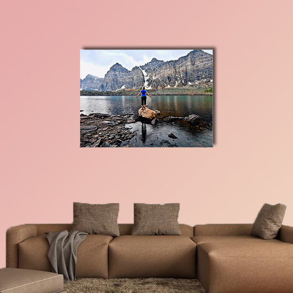 Blond woman by alpine lake enjoying the mountain view wall art