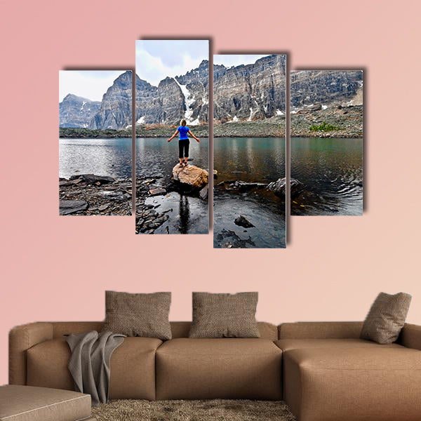 Blond woman by alpine lake enjoying the mountain view wall art