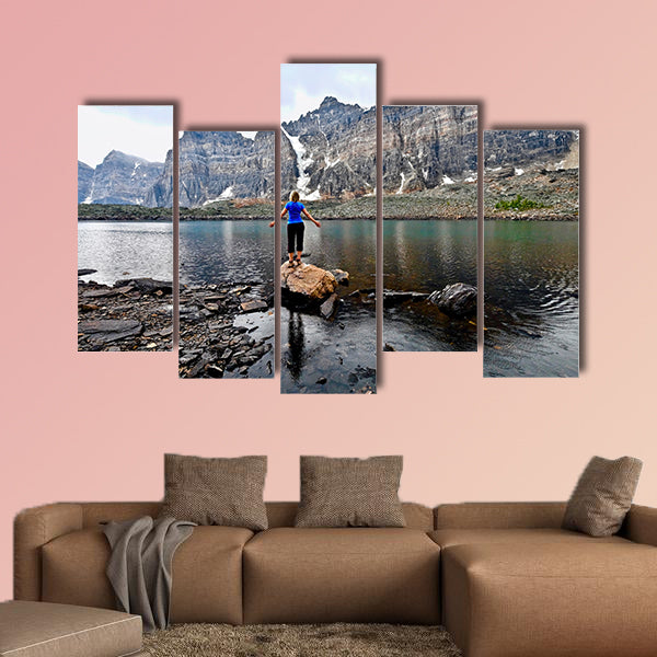 Blond woman by alpine lake enjoying the mountain view wall art