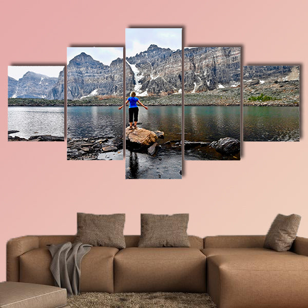 Blond woman by alpine lake enjoying the mountain view wall art
