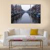 Along the canal walk citizens and moving vehicles Multi panel canvas wall art