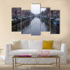 Along the canal walk citizens and moving vehicles Multi panel canvas wall art