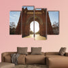 Cyclist rides into the Arc de Triomph sunny morning Barcelona, Spain canvas wall art