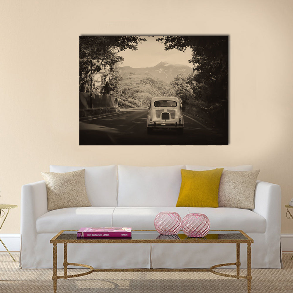 Sepia photo of a retro car going to mountains Multi panel canvas wall art