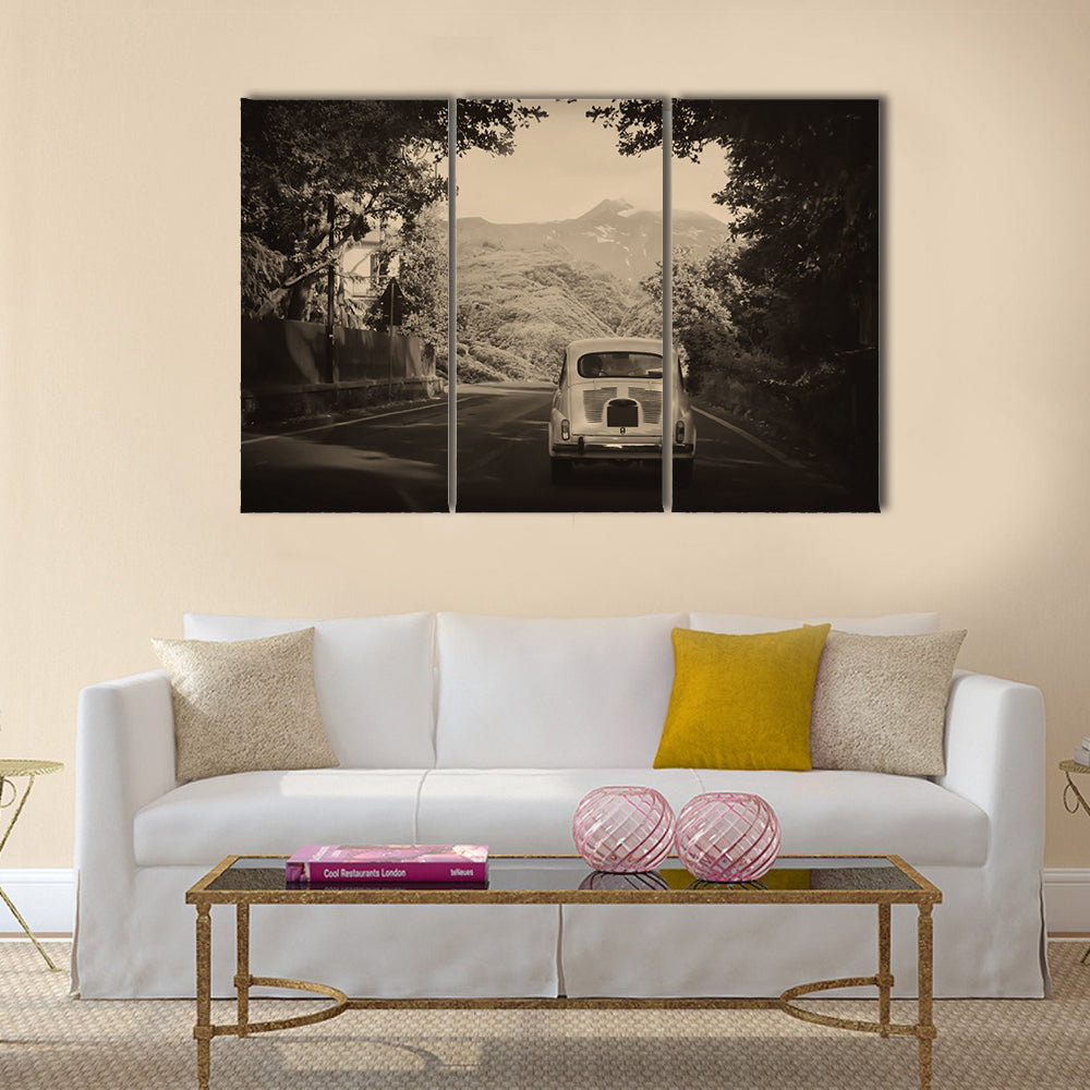 Sepia photo of a retro car going to mountains Multi panel canvas wall art