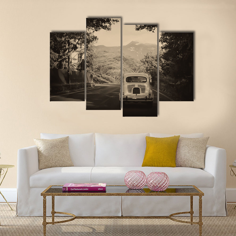 Sepia photo of a retro car going to mountains Multi panel canvas wall art