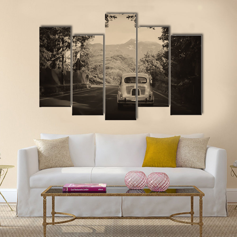Sepia photo of a retro car going to mountains Multi panel canvas wall art