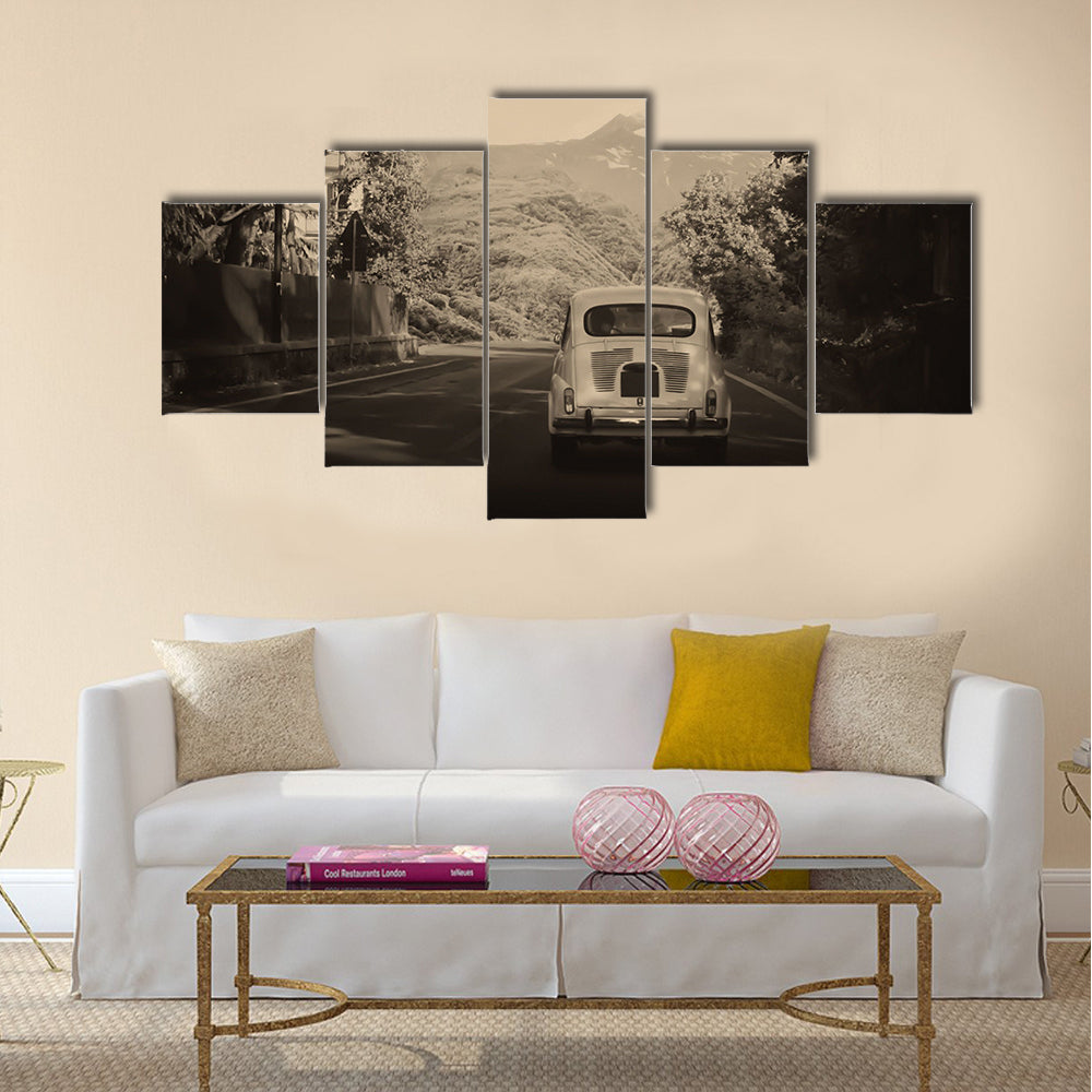 Sepia photo of a retro car going to mountains Multi panel canvas wall art