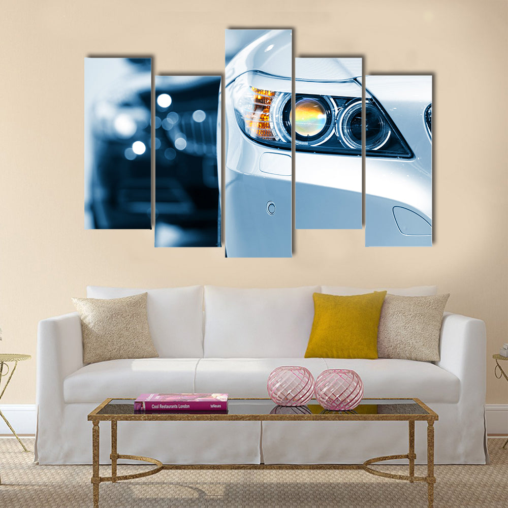 Close up shot of car head lamp in blue color tone Multi panel canvas wall art