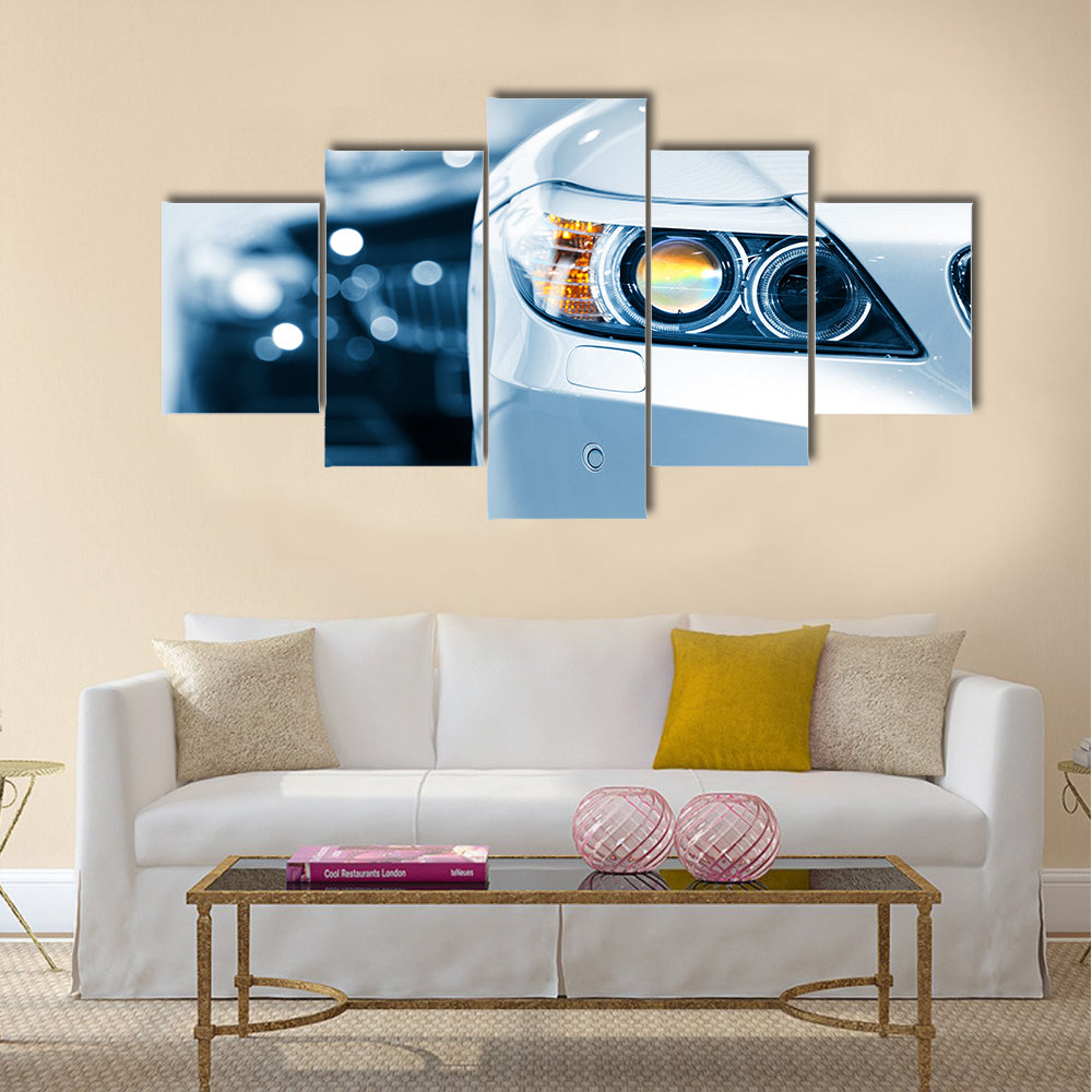 Close up shot of car head lamp in blue color tone Multi panel canvas wall art