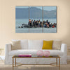 Refugee migrants, arrived on Lesvos in inflatable dinghy boats Multi Panel Canvas Wall Art