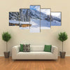 Chad with firewood in Austrian Alps during winter time Multi panel canvas wall art