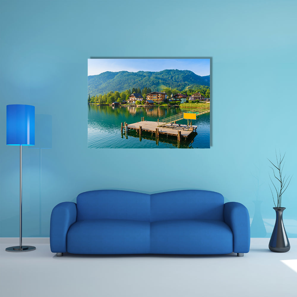 Wooden pier for boats on shore of Weissensee alpine lake in summer landscape, Austria multi panel canvas wall art