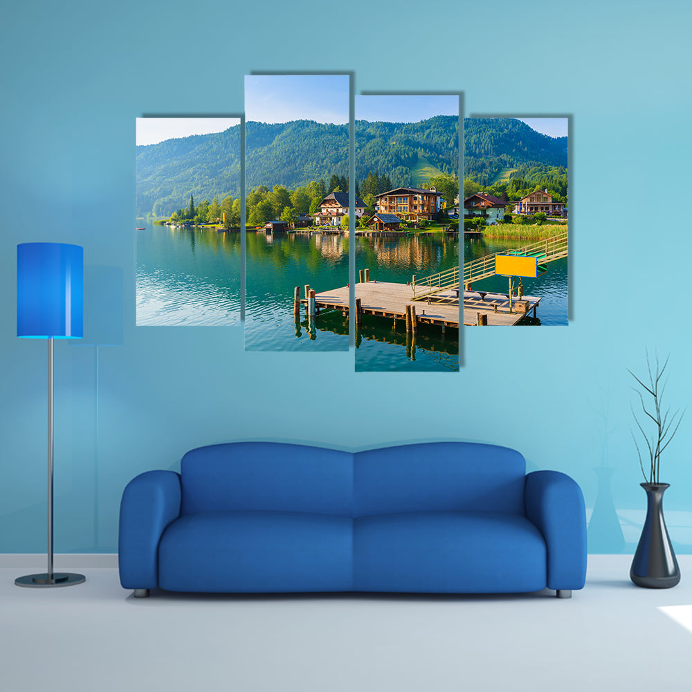 Wooden pier for boats on shore of Weissensee alpine lake in summer landscape, Austria multi panel canvas wall art