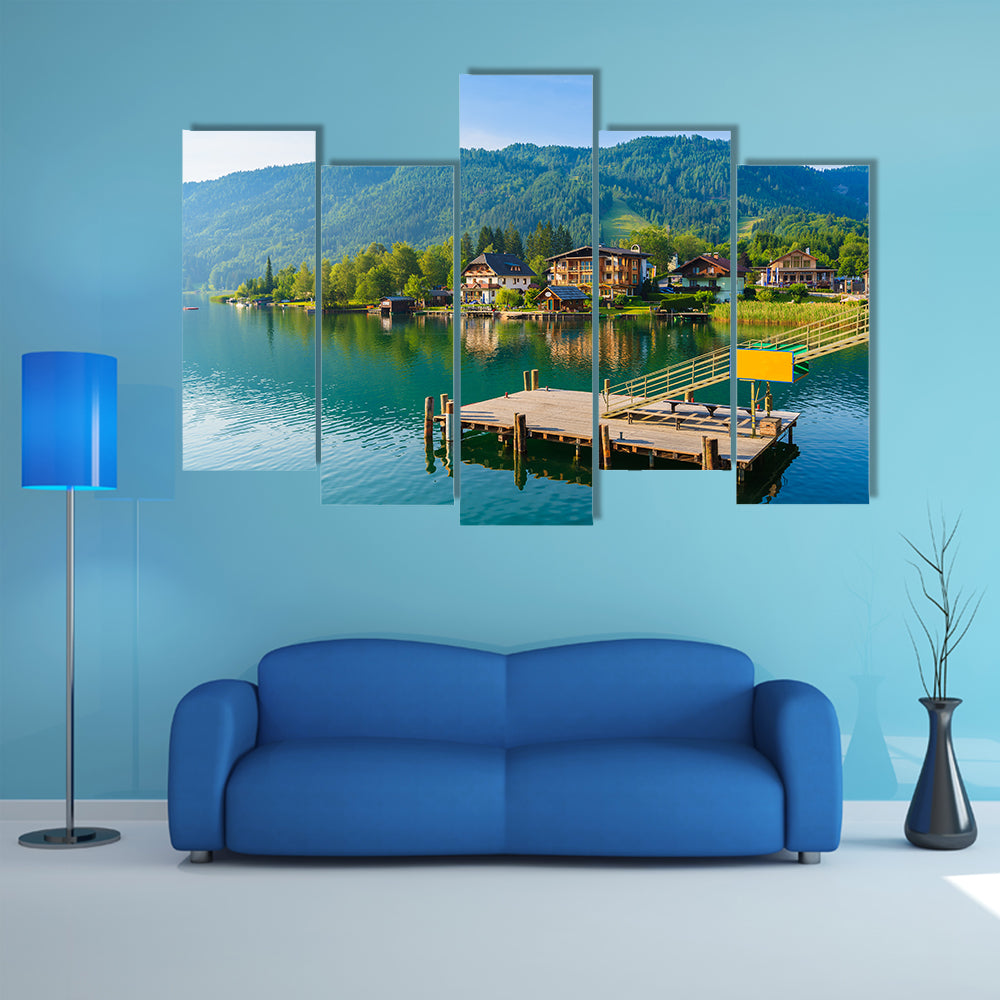 Wooden pier for boats on shore of Weissensee alpine lake in summer landscape, Austria multi panel canvas wall art