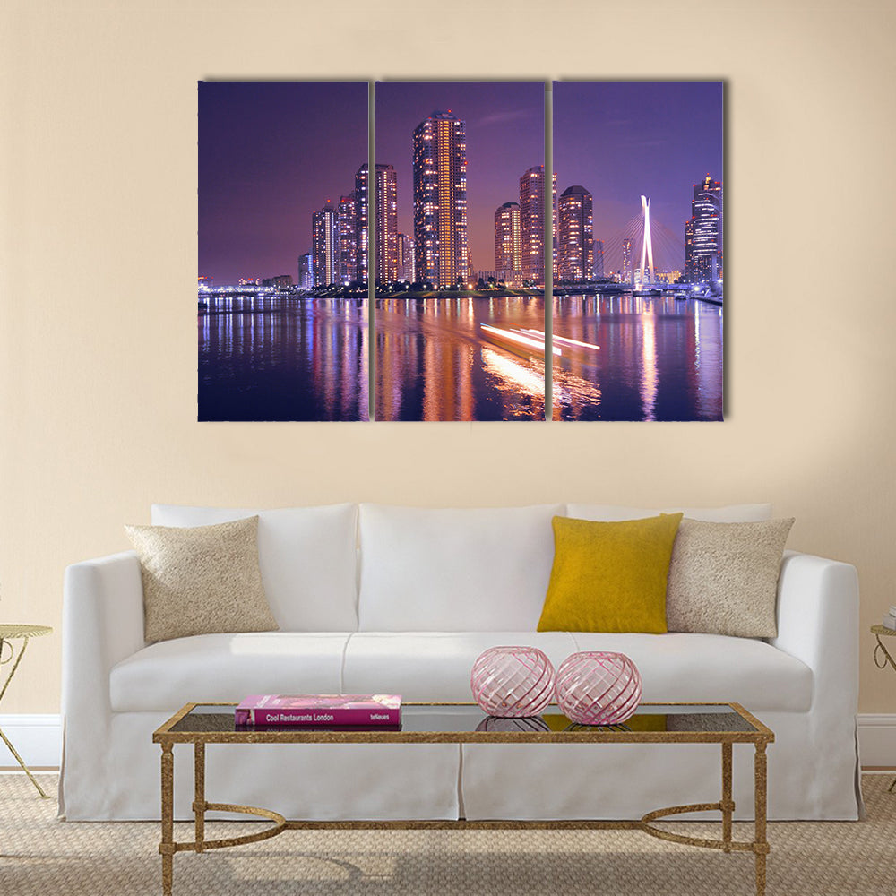 Modern Tokyo buildings with night reflection in water and light traces of moving ship, Japan Multi Panel Canvas Wall Art
