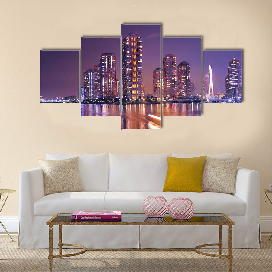Modern Tokyo buildings with night reflection in water and light traces of moving ship, Japan Multi Panel Canvas Wall Art