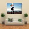 Successful silhouette man winner waving Suriname flag on top of the mountain peak Multi Panel Canvas Wall Art