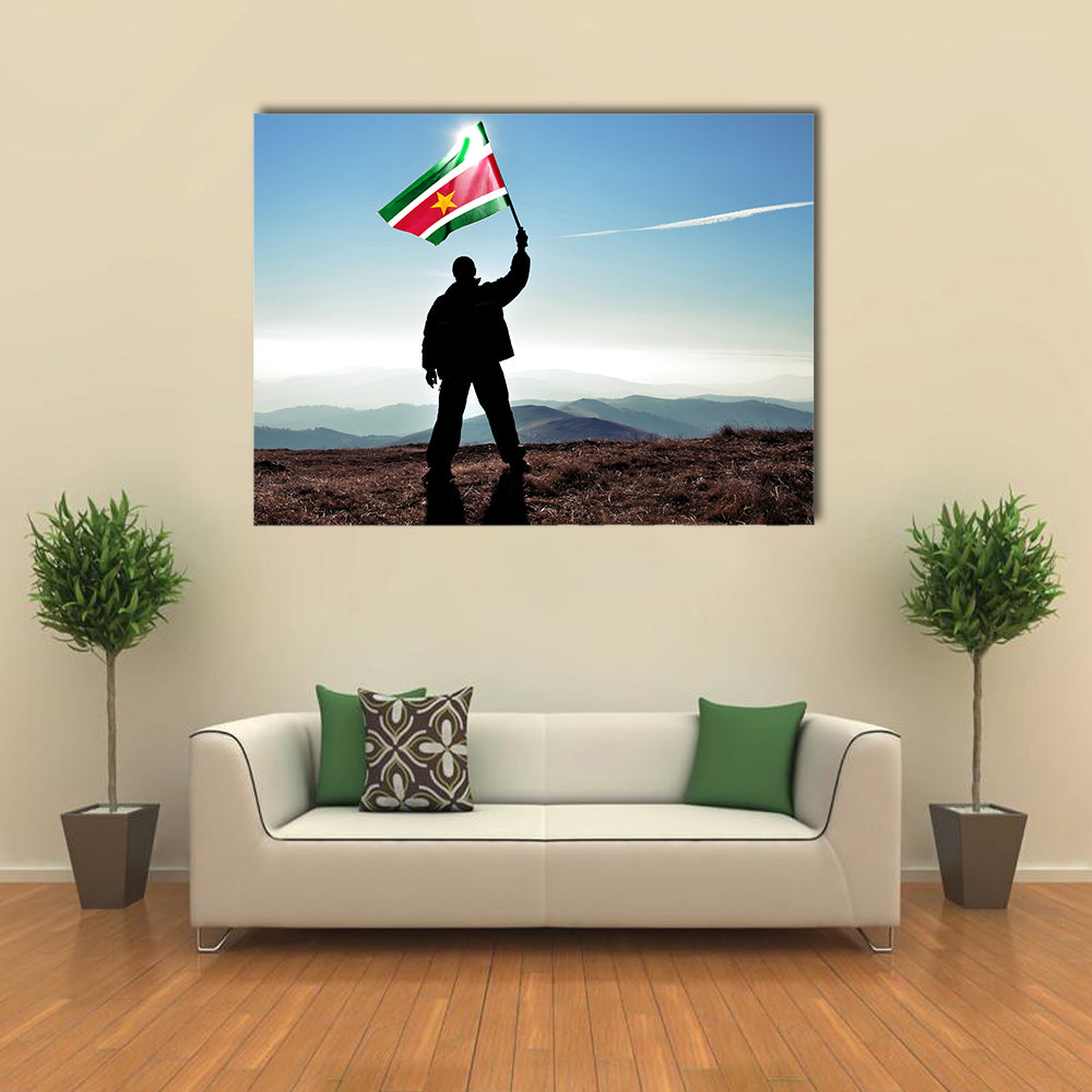 Successful silhouette man winner waving Suriname flag on top of the mountain peak Multi Panel Canvas Wall Art
