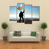 Successful silhouette man winner waving Suriname flag on top of the mountain peak Multi Panel Canvas Wall Art