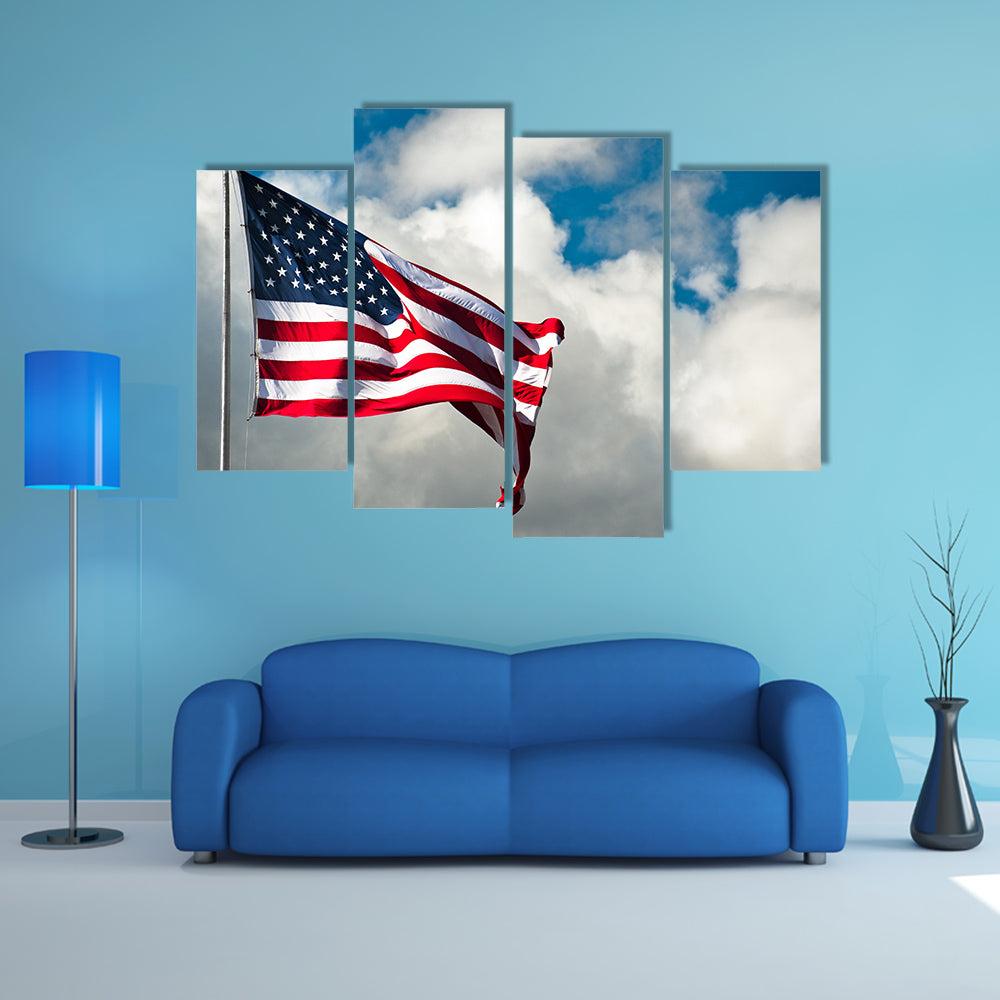 American flag against a cloudy sky on a windy day Multi panel canvas wall art