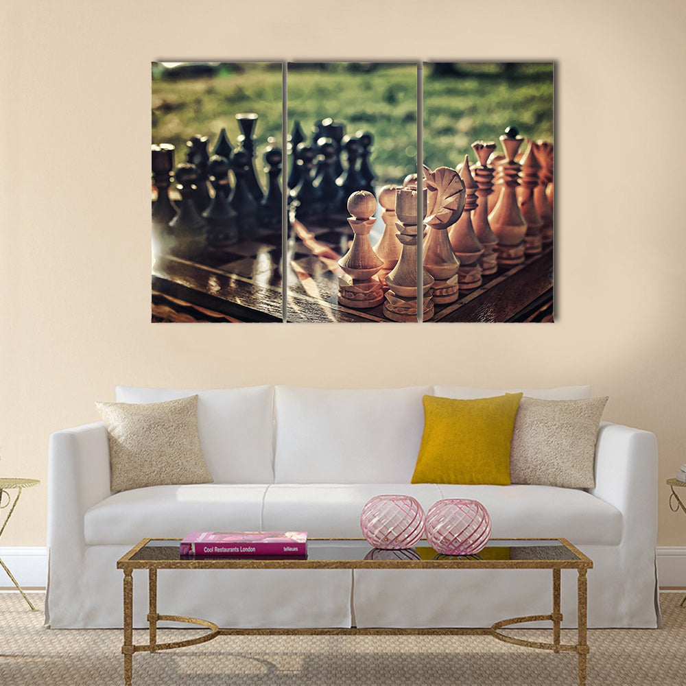 chess pieces arranged on the board mid-game in the fresh air multi panel canvas wall art