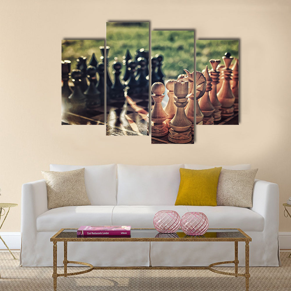 chess pieces arranged on the board mid-game in the fresh air multi panel canvas wall art