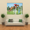 The rider on the red show jumper horse overcome high obstacles multi panel canvas wall art