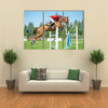 The rider on the red show jumper horse overcome high obstacles multi panel canvas wall art