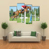 The rider on the red show jumper horse overcome high obstacles multi panel canvas wall art