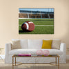 American football on field with goal post in background Multi panel canvas wall art