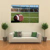 American football on field with goal post in background Multi panel canvas wall art