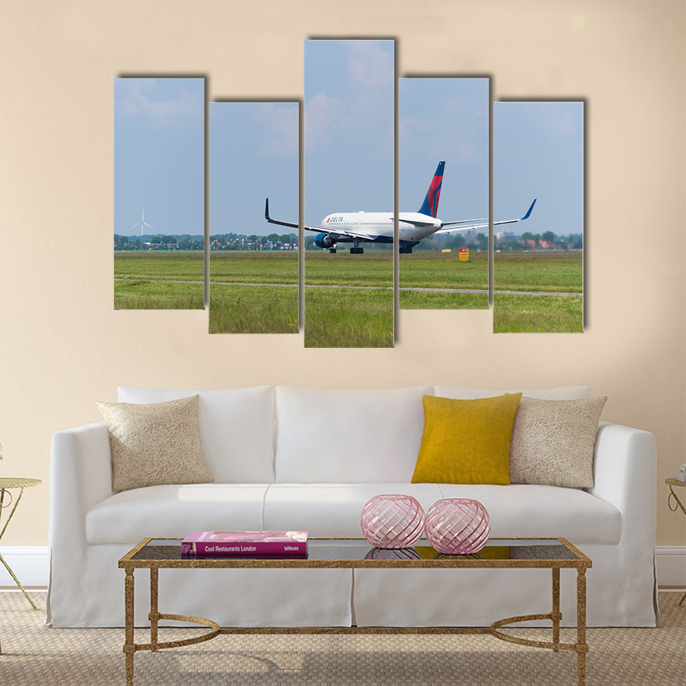 Delta airlines plane takes off at Amsterdam international airport multi panel canvas wall art