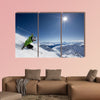 Female skier on downhill race with sun and Mountain View Multi panel canvas wall art