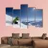 Female skier on downhill race with sun and Mountain View Multi panel canvas wall art