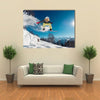 Girl is jumping with snowboard from the hill Multi panel canvas wall art